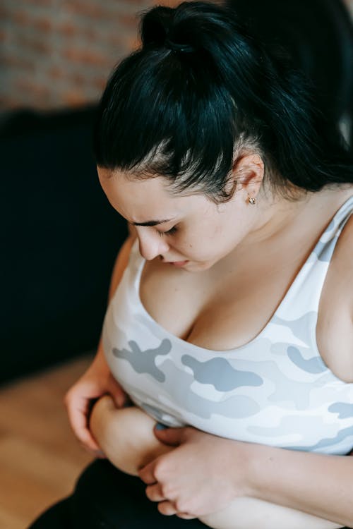 Person measuring waist to track body contouring progress