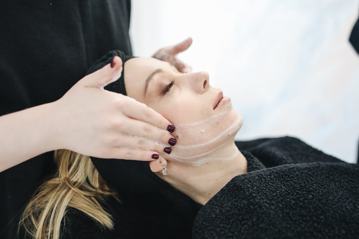 Woman receiving professional facial skin treatment at a spa clinic