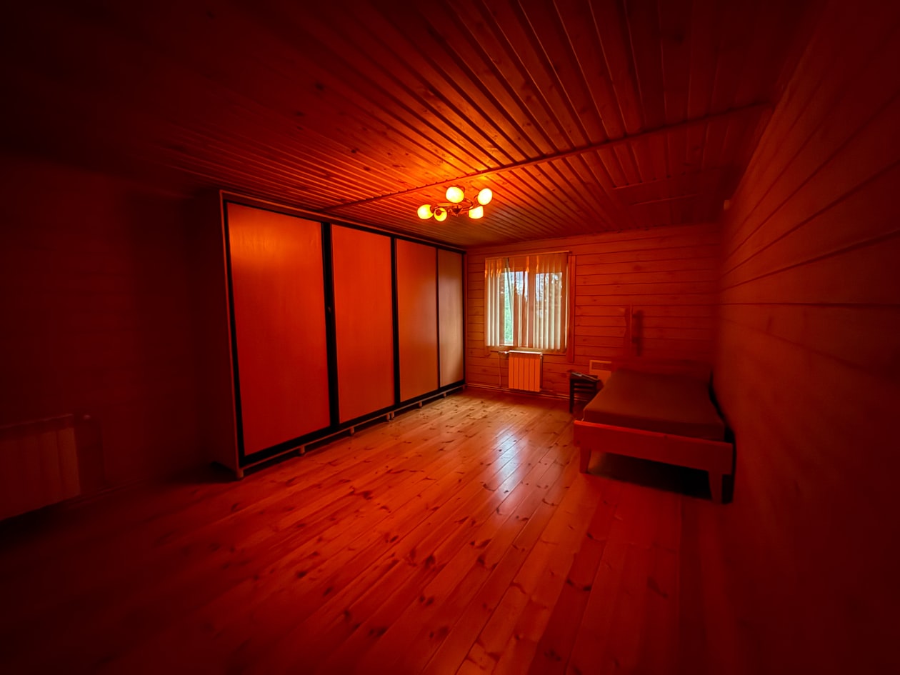 Room bathed in deep red light therapy wavelengths for full-body photobiomodulation