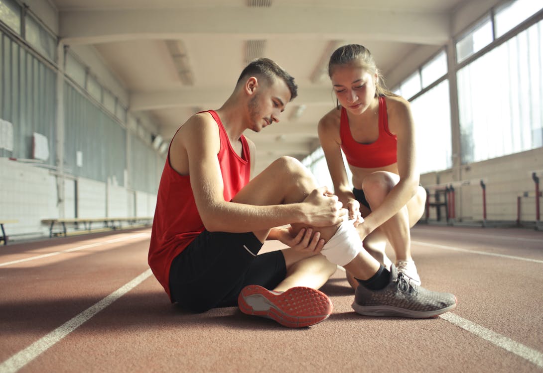Physical therapist wrapping a patient's leg during recovery treatment