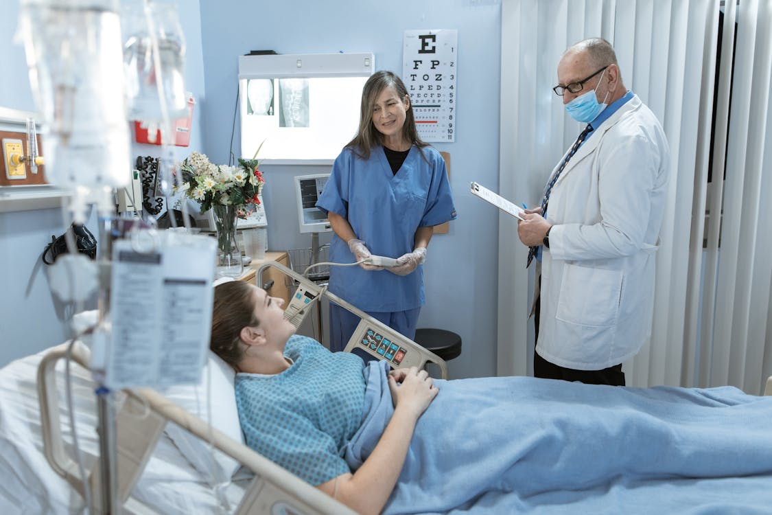 Doctor attending to a patient during post-surgery recovery