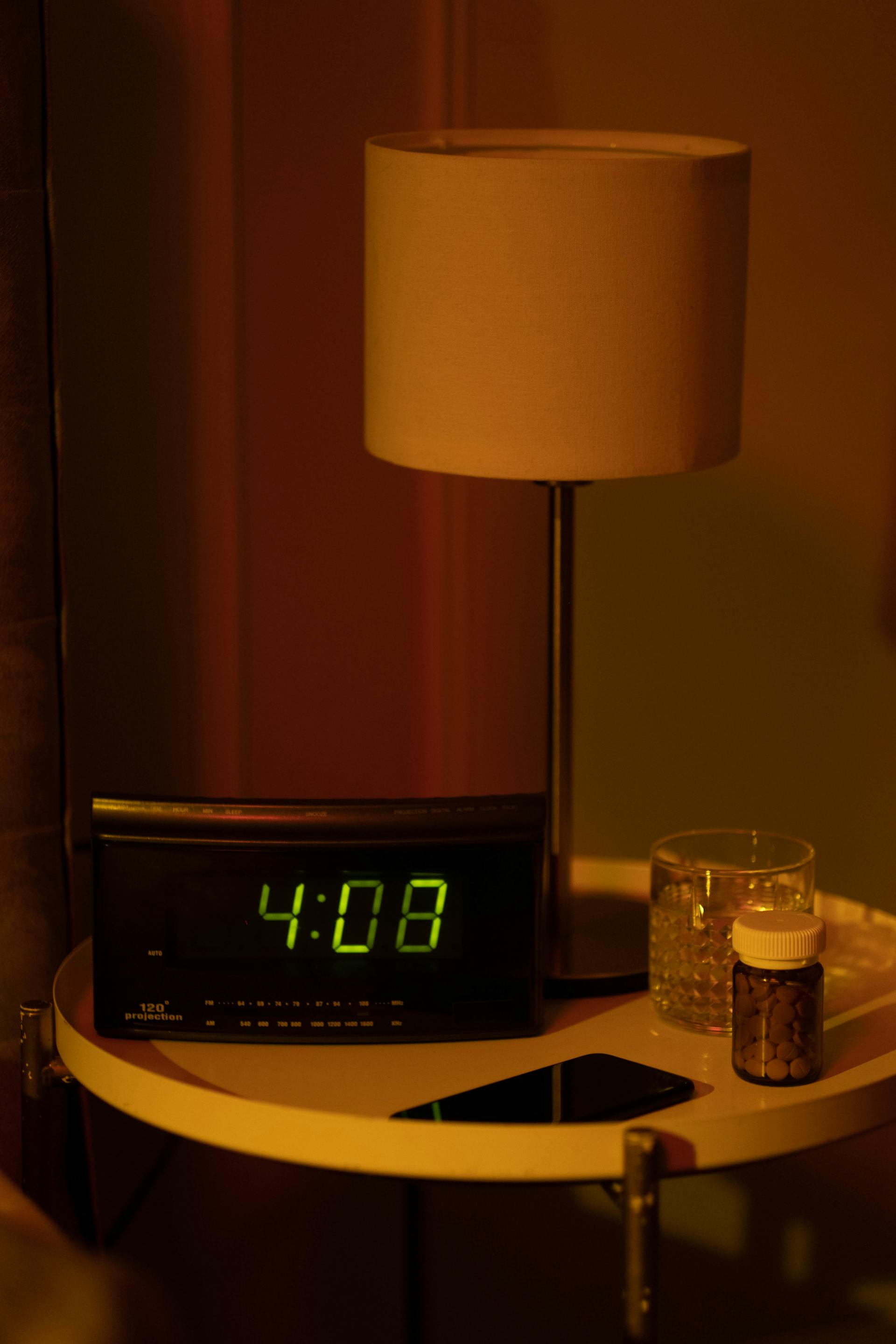 Bedside table with clock showing nighttime