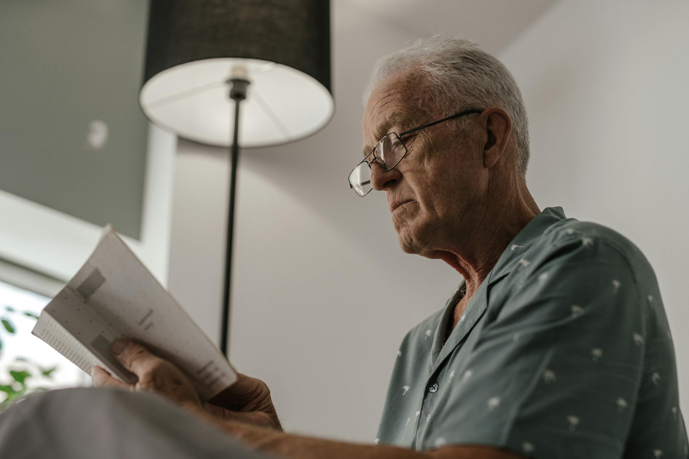 Senior person reading clearly with good vision in natural morning light